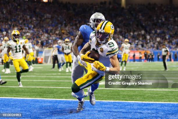 Christian Watson of the Green Bay Packers catches a pass for a touchdown against the Detroit Lions during the third quarter of the game at Ford Field...