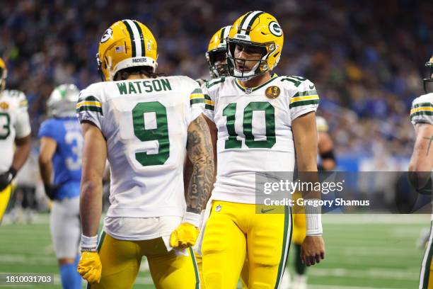 Christian Watson of the Green Bay Packers celebrates with teammate Jordan Love after scoring a touchdown against the Detroit Lions during the third...