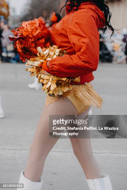 cheerleader walking during parade - body part foto e immagini stock