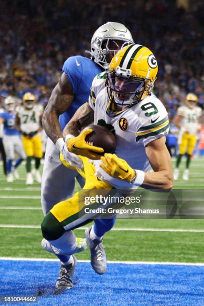 Christian Watson of the Green Bay Packers catches a pass for a touchdown against the Detroit Lions during the third quarter of the game at Ford Field...