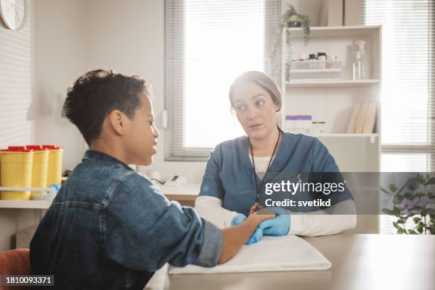 child with arm injury at doctors office - elbow bandage stock pictures, royalty-free photos & images