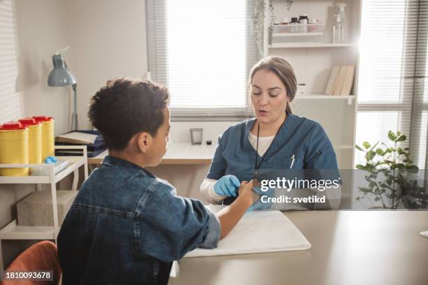 child with arm injury at doctors office - elbow bandage stock pictures, royalty-free photos & images