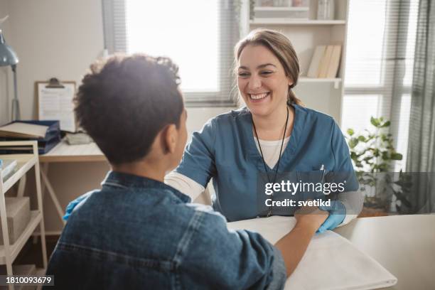 child with arm injury at doctors office - elbow bandage stock pictures, royalty-free photos & images
