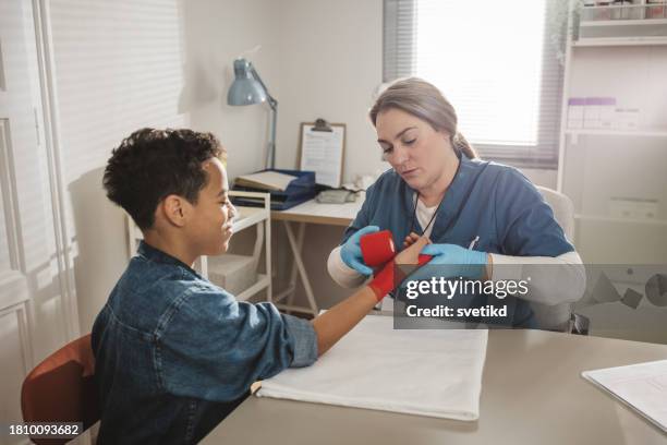 child with arm injury at doctors office - elbow bandage stock pictures, royalty-free photos & images