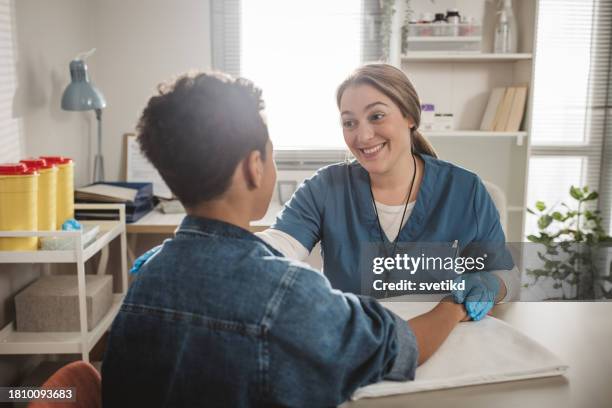 child with arm injury at doctors office - elbow bandage stock pictures, royalty-free photos & images