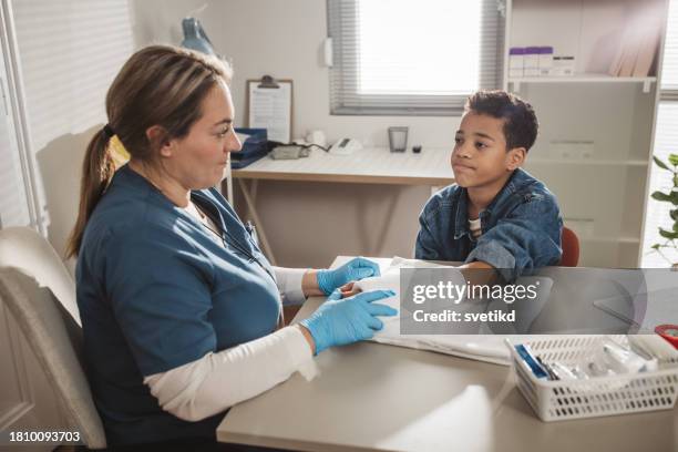child with arm injury at doctors office - elbow bandage stock pictures, royalty-free photos & images