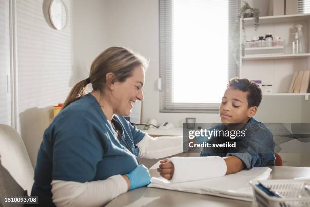 child with arm injury at doctors office - elbow bandage stock pictures, royalty-free photos & images
