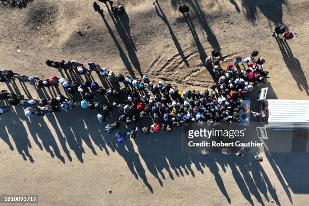 Jacumba, CA, Friday, November 24, 2023 - Asylum seekers from China, Colombia and the Middle East camp near the border wall, often waiting days to be...