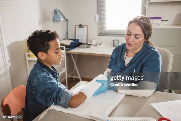 child with arm injury at doctors office - elbow bandage stock pictures, royalty-free photos & images