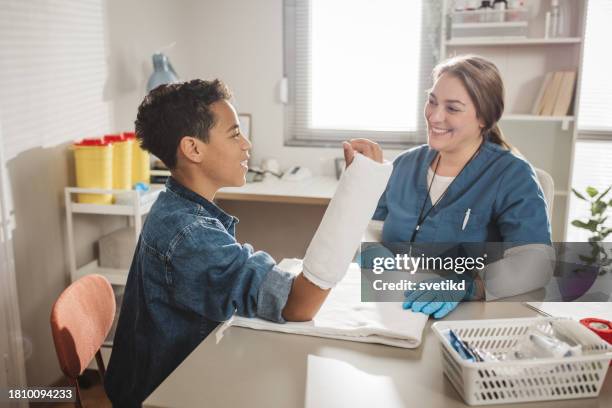 child with arm injury at doctors office - elbow bandage stock pictures, royalty-free photos & images