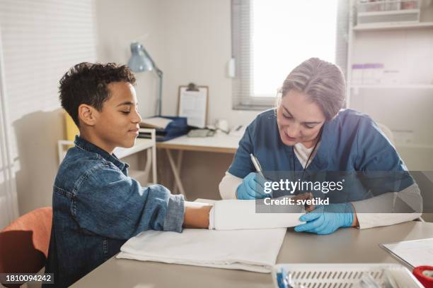 child with arm injury at doctors office - cast of bones stock pictures, royalty-free photos & images