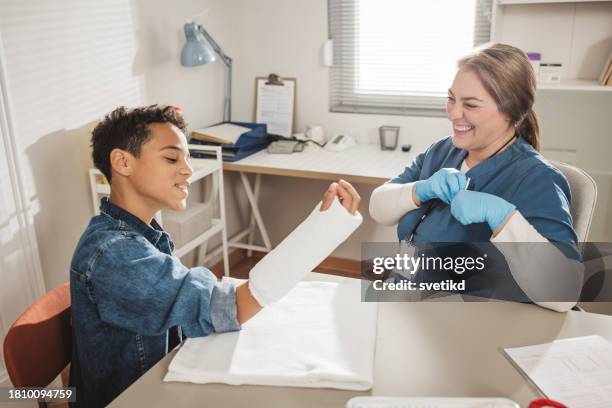 child with arm injury at doctors office - elbow bandage stock pictures, royalty-free photos & images