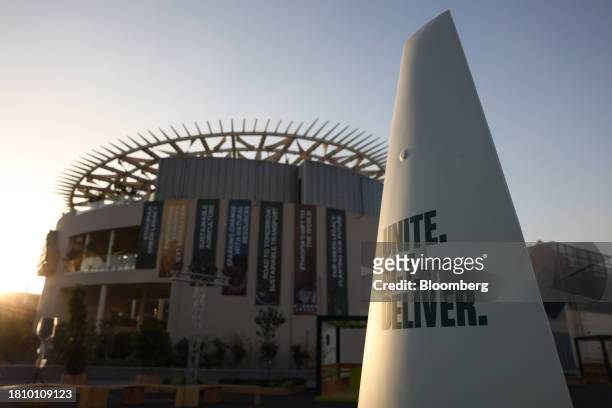 Sign reading 'Unite. Act. Deliver' in the Blue Zone ahead of the COP28 climate conference at Expo City in Dubai, United Arab Emirates, on Wednesday,...