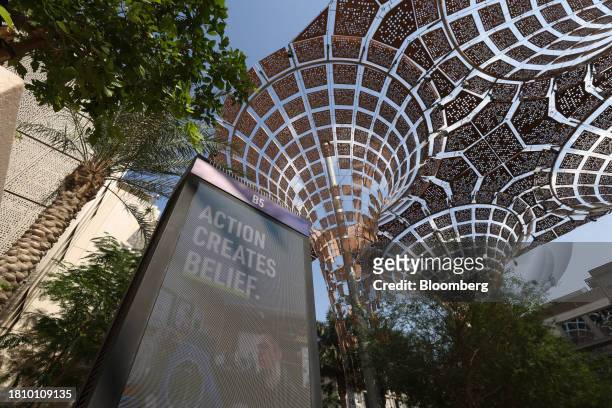 An electronic sign reading 'Action Creates Belief' in the Blue Zone ahead of the COP28 climate conference at Expo City in Dubai, United Arab...