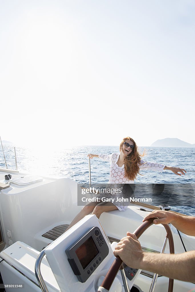 Young woman laughing on yacht