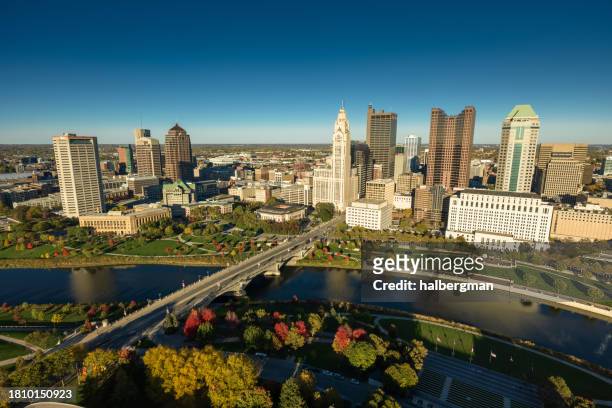 drone view of downtown columbus on clear, fall day - river scioto stock pictures, royalty-free photos & images