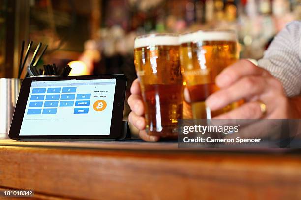 In this photo illustration, a terminal to accept payments using bitcoins is displayed on the bar at the Old Fitzroy pub on September 19, 2013 in...