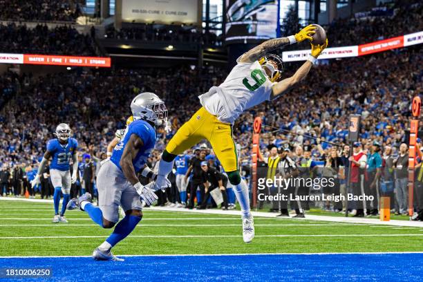 Christian Watson of the Green Bay Packers scores a touchdown after a catch in the third quarter of the game against the Detroit Lions at Ford Field...