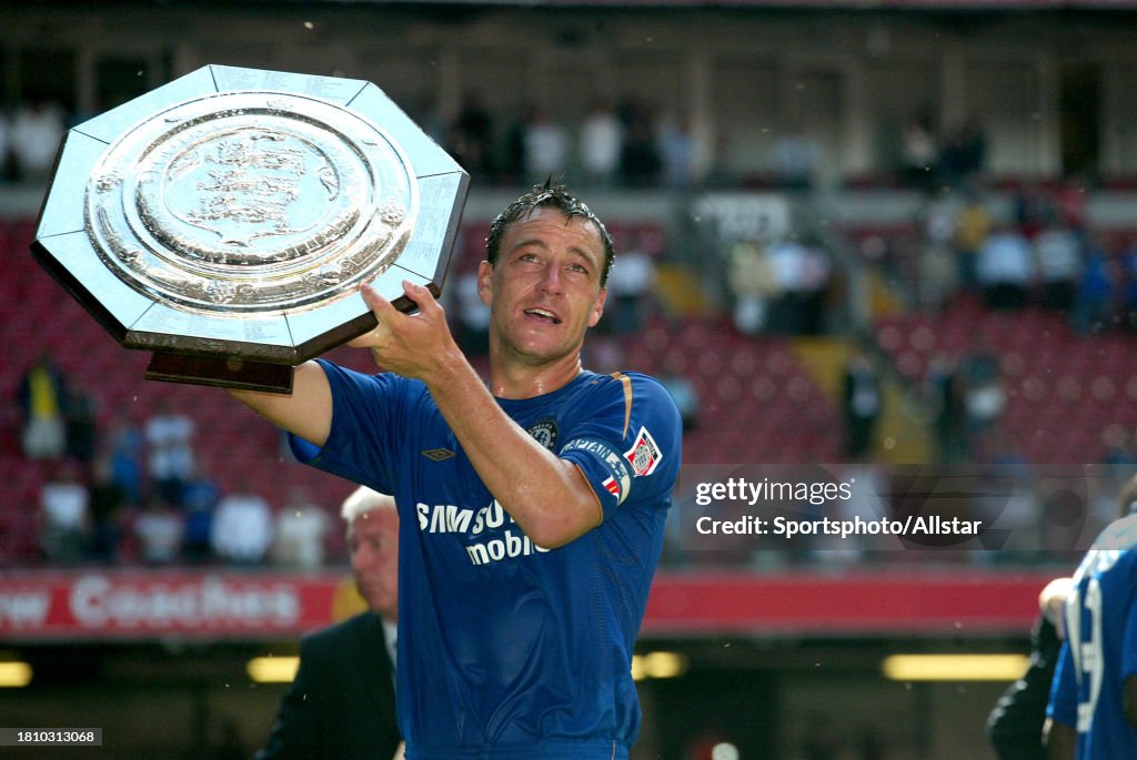 John Terry celebrates with the trophy after the FA Community