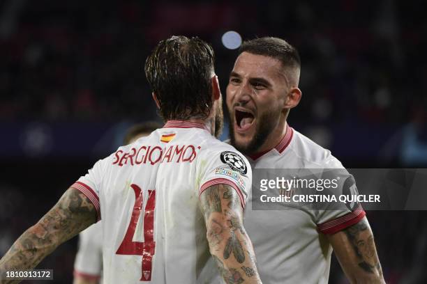 Sevilla's Spanish defender Sergio Ramos celebrates scoring the opening goal, with Sevilla's Serbian midfielder Nemanja Gudelj, during the UEFA...