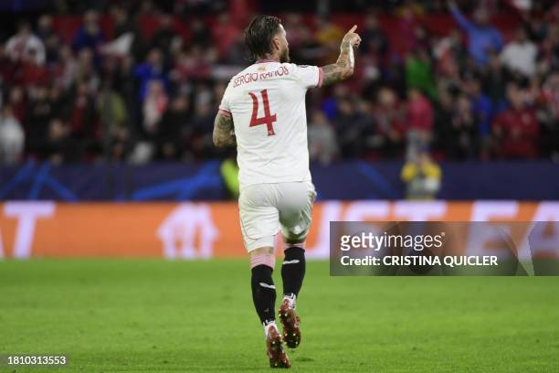 Sevilla's Spanish defender Sergio Ramos celebrates scoring the opening goal during the UEFA Champions League first round group B football match...