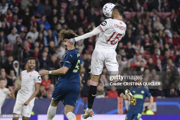 Sevilla's Moroccan forward Youssef En-Nesyri a header over PSV's Brazilian defender Andre Ramalho during the UEFA Champions League first round group...