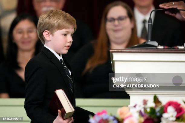 Great grandchild Charles Jeffrey Carter walks with a Bible to read a scripture during the funeral service for former first lady Rosalynn Carter at...