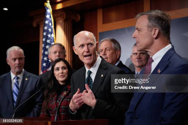 At center, Sen. Rick Scott speaks during a news conference with members of the House Freedom Caucus at the U.S. Capitol November 29, 2023 in...