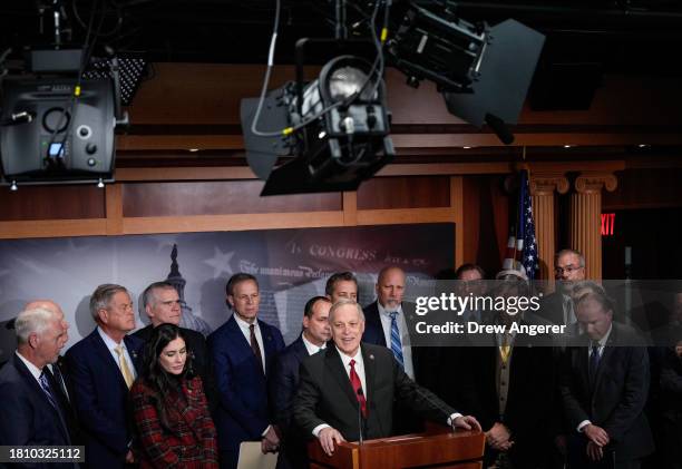 At center, Rep. Andy Biggs speaks during a news conference with members of the House Freedom Caucus at the U.S. Capitol November 29, 2023 in...