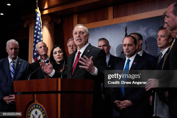 At center, Rep. Andy Biggs speaks during a news conference with members of the House Freedom Caucus at the U.S. Capitol November 29, 2023 in...