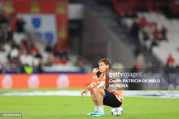 Inter Milan's Italian midfielder Nicolo Barella sits on a ball on the pitch during warm up prior to the UEFA Champions League first round group D...