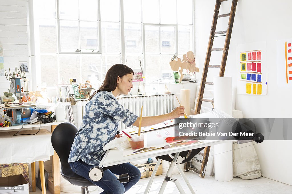 Female artist working in studio.