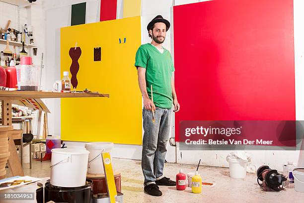 artist in studio working on painting. - art room stock pictures, royalty-free photos & images