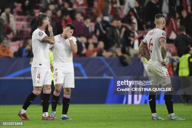 Sevilla's Spanish defender Sergio Ramos, Sevilla's Argentinian defender Marcos Acuna and Sevilla's Serbian midfielder Nemanja Gudelj react to their...