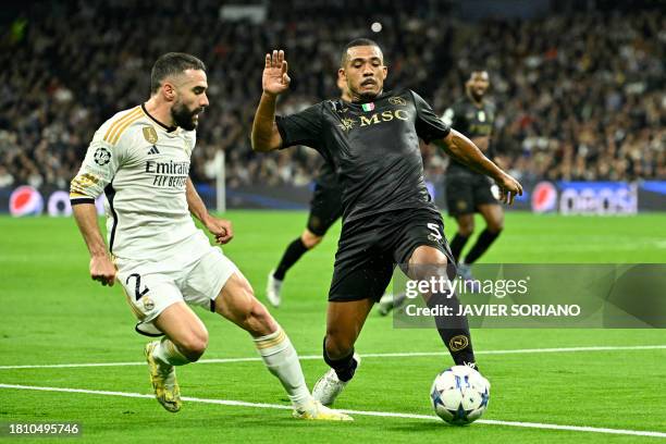 Real Madrid's Spanish defender Dani Carvajal vies with Napoli's Brazilian defender Juan Jesus during the UEFA Champions League first round group C...