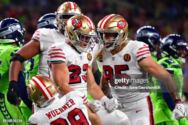 Christian McCaffrey of the San Francisco 49ers celebrates a touchdown during the second quarter of a game against the Seattle Seahawks at Lumen Field...