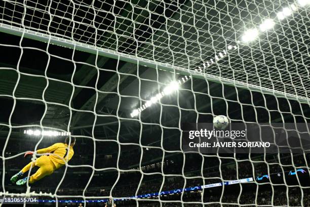 Napoli's Italian goalkeeper Alex Meret concedes a second goal scored by Real Madrid's English midfielder Jude Bellingham during the UEFA Champions...