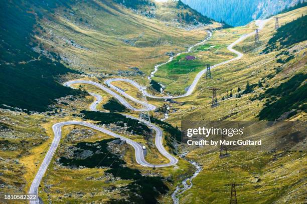 the transfagarasan highway winding its way up a steep valley near balea lake, transylvania, romania - main road stock pictures, royalty-free photos & images