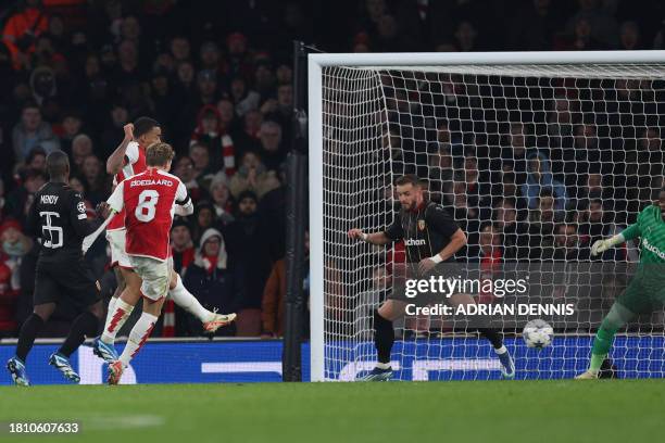 Arsenal's Norwegian midfielder Martin Odegaard scores his team's fifth goal during the UEFA Champions League Group B football match between Arsenal...