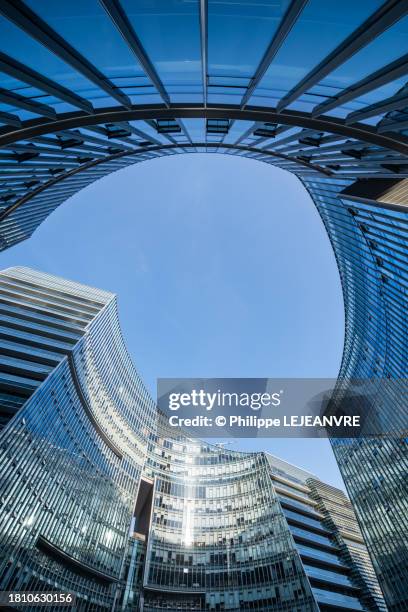Modern Curved Glass Buildings Against Clear Blue Sky High-Res Stock Photo