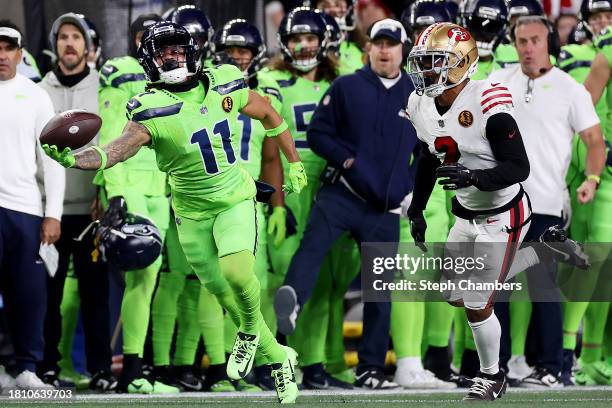 Jaxon Smith-Njigba of the Seattle Seahawks hauls in a one-handed catch in front of Deommodore Lenoir of the San Francisco 49ers during the third...