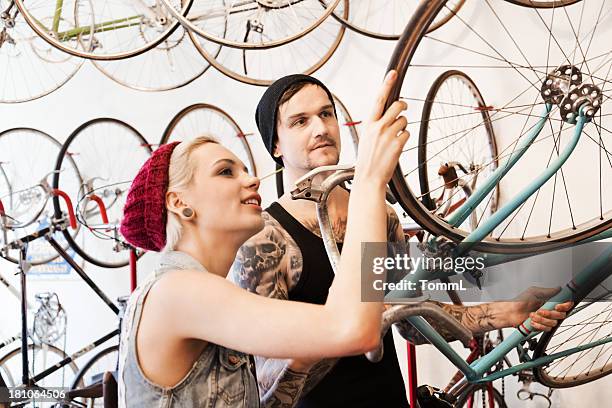 couple in a bike store - buying a bike bildbanksfoton och bilder