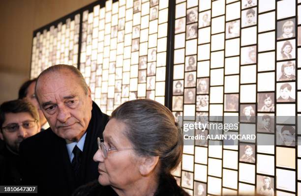 French former President Jacques Chirac and French former Minister Simone Veil , former Auschwitz death camp's survivor, look at photographs of...