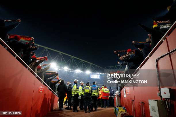 Police officers stand between sections of Lens supporters during the UEFA Champions League Group B football match between Arsenal and RC Lens at the...