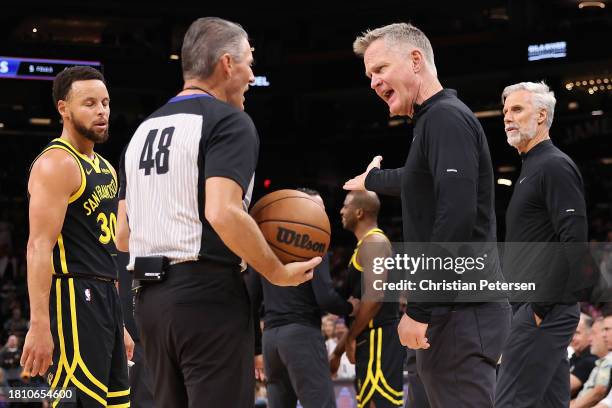 Head coach Steve Kerr of the Golden State Warriors reacts to referee Scott Foster during the first half of the NBA game at Footprint Center on...