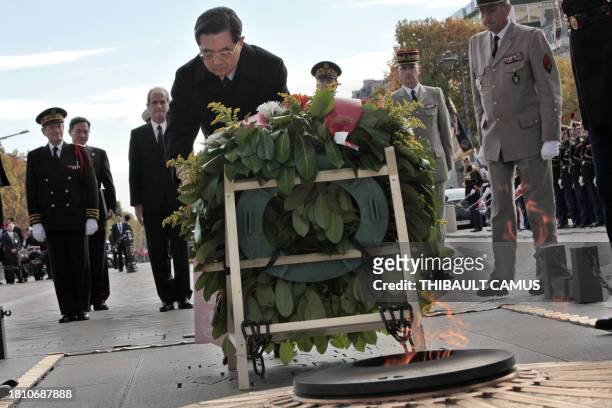 Chinese President Hu Jintao lays a wreath at the unknown soldier's tomb, at the Arc of Triomphe, in Paris on November 5, 2010. The three-day state...