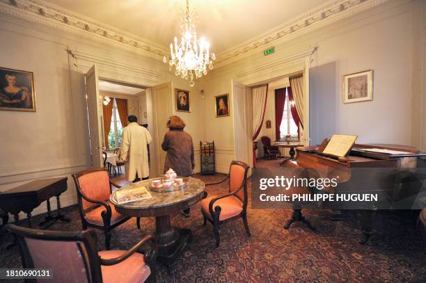 Visitors leave the living room of the Charles de Gaulle's birthhouse on November 3, 2010 in Lille, northern France. France will commemorate in...