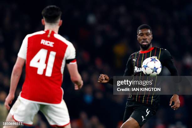 Arsenal's English midfielder Declan Rice watches as Lens' Austrian defender Kevin Danso controls the ball during the UEFA Champions League Group B...