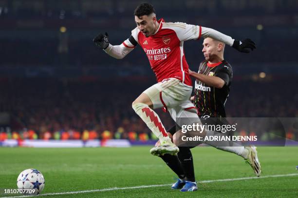 Arsenal's Brazilian midfielder Gabriel Martinelli beats Lens' Polish defender Przemyslaw Frankowski during the UEFA Champions League Group B football...