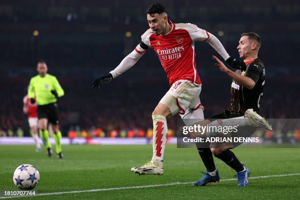 Arsenal's Brazilian midfielder Gabriel Martinelli beats Lens' Polish defender Przemyslaw Frankowski during the UEFA Champions League Group B football...